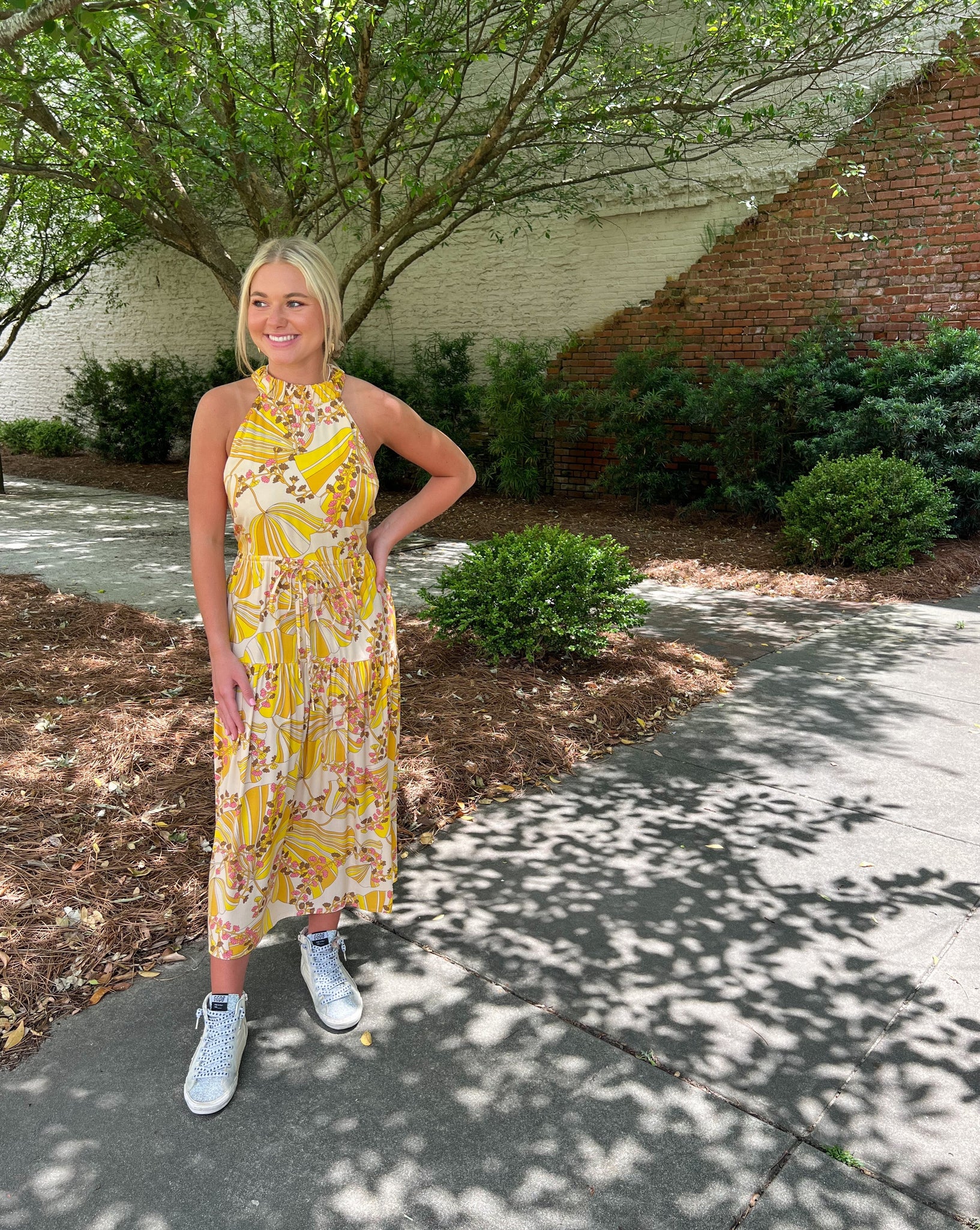 Yellow halter neck dress with criss cross back.