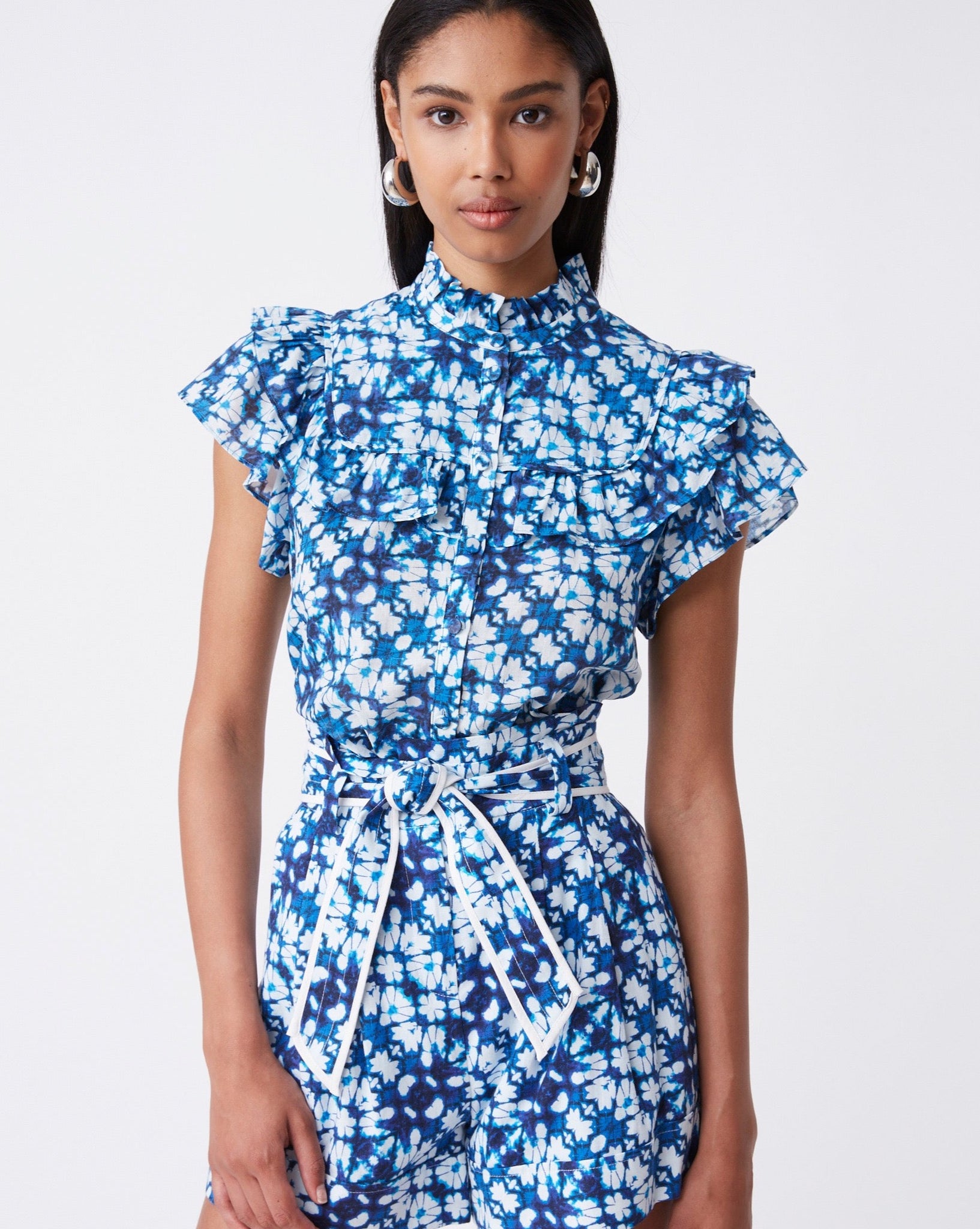 Blue and white cotton top with ruffle detail by Suncoo.